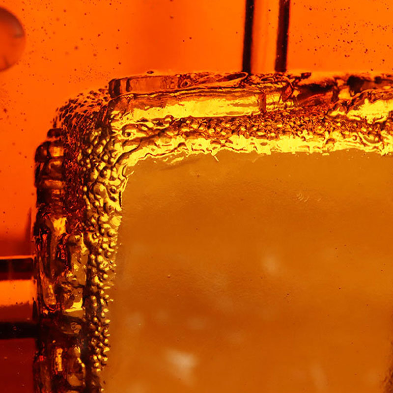 Punainen lasinen tuhkakuppi upeilla kohokuvioiduilla eläinkuvioilla