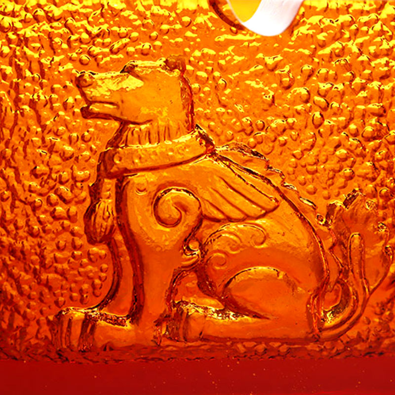 Punainen lasinen tuhkakuppi upeilla kohokuvioiduilla eläinkuvioilla